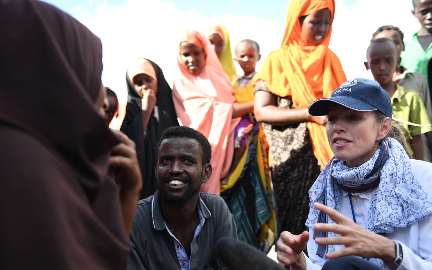 Yngvil Foss, the Deputy Head of the United Nations Office for the Coordination of Humanitarian Affairs, interacts with a family of flood victims on the outskirts of Belet Weyne. The city at the time experienced its worst flooding ever with over 150,000 people displaced.