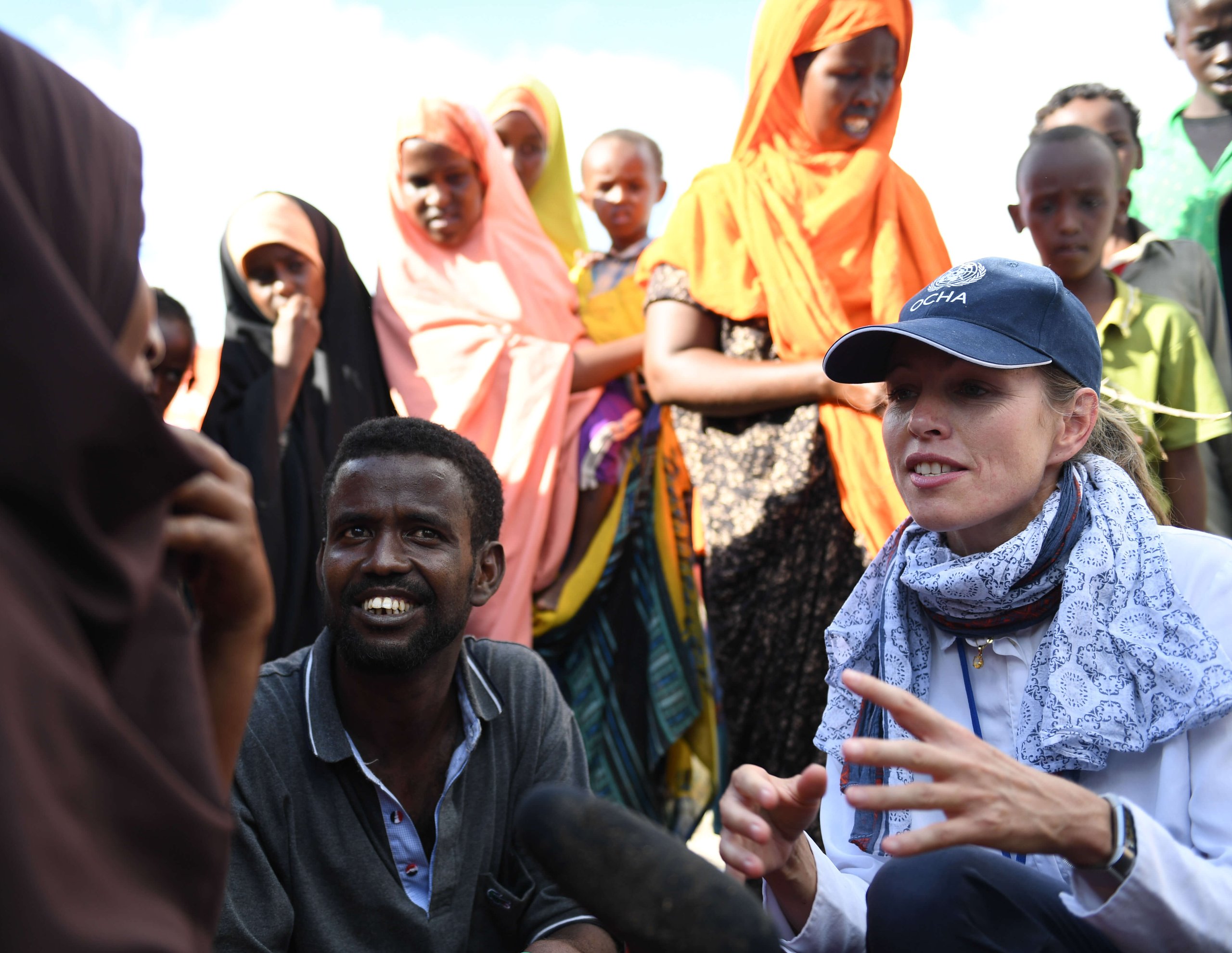 Yngvil Foss, the Deputy Head of the United Nations Office for the Coordination of Humanitarian Affairs, interacts with a family of flood victims on the outskirts of Belet Weyne. The city at the time experienced its worst flooding ever with over 150,000 people displaced.