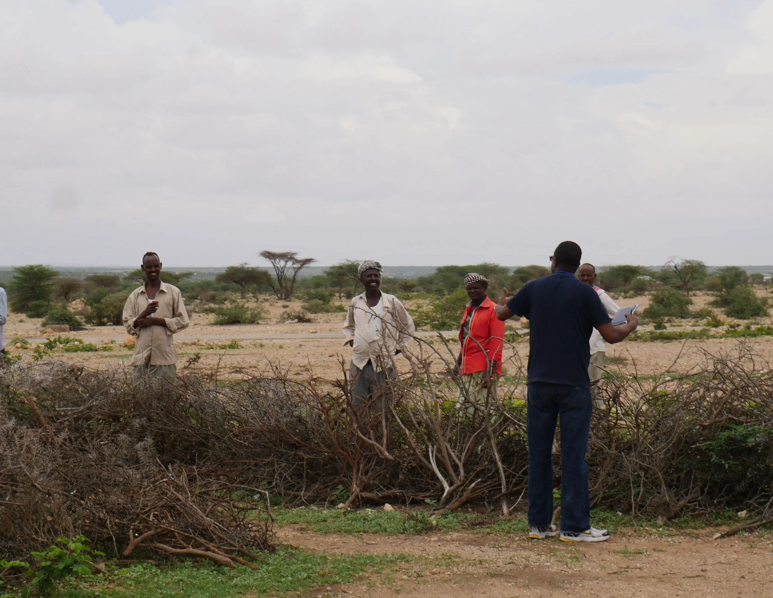 A photo of TS researchers engaging rural residents in conversation during a field visit.